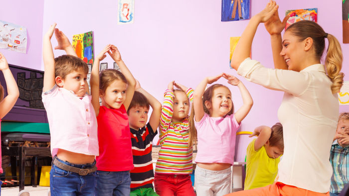 Children imitating teacher's hand gesture