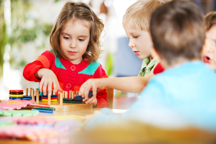 Teaching cooperation - children sharing toys