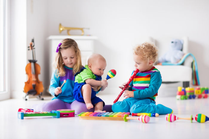 Three little siblings with musical instruments