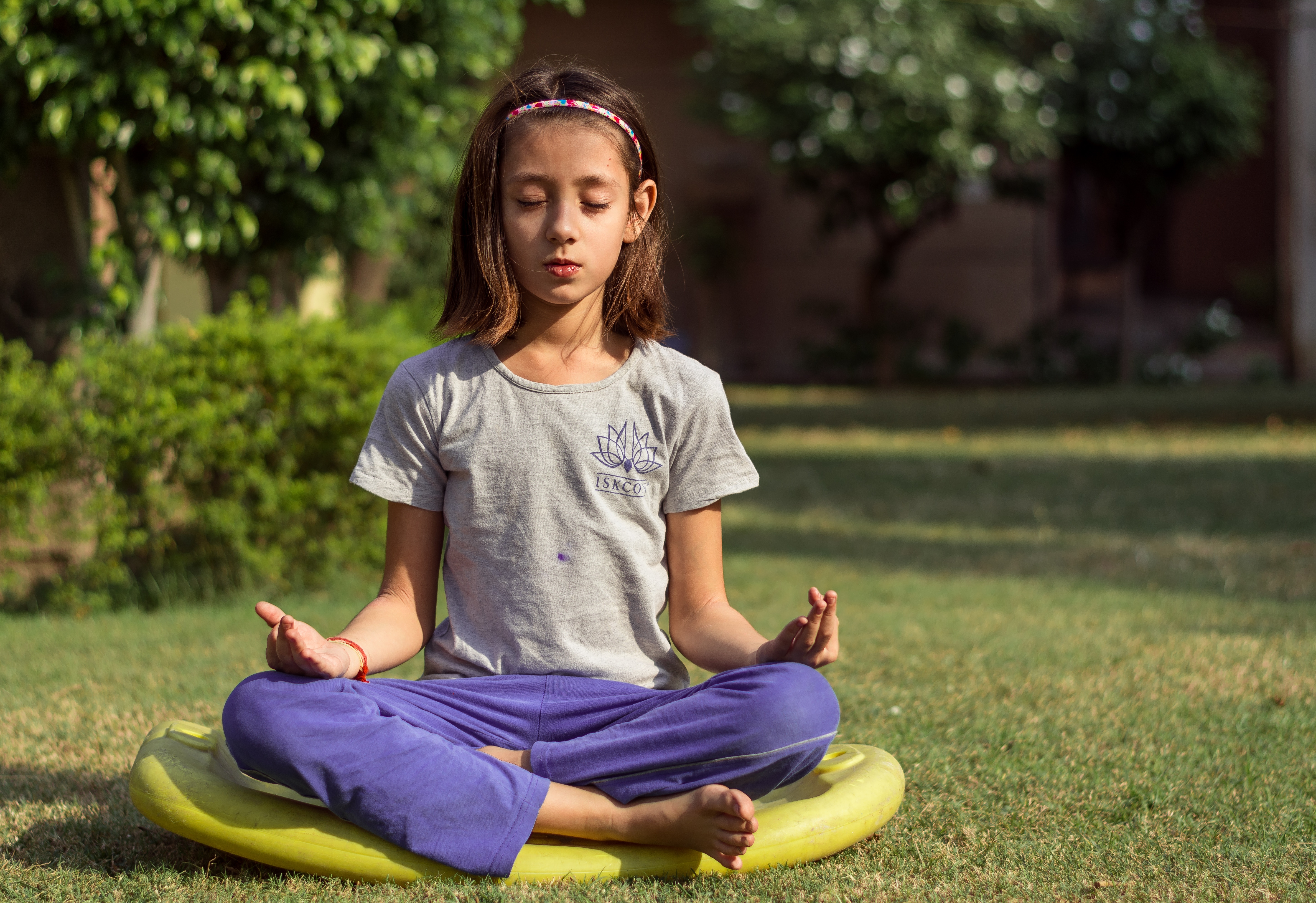 Teaching kids mindfulness - young girl meditating
