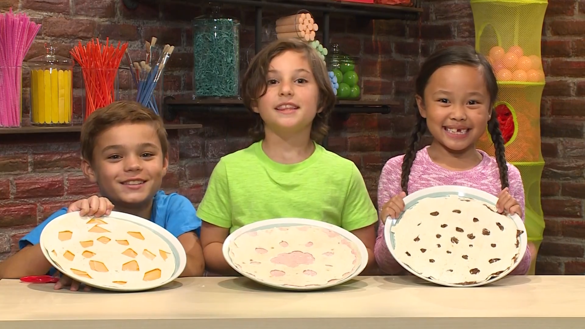 Photo of Children Holding Up Snowflake Tortillas