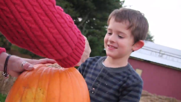 kid with pumpkin