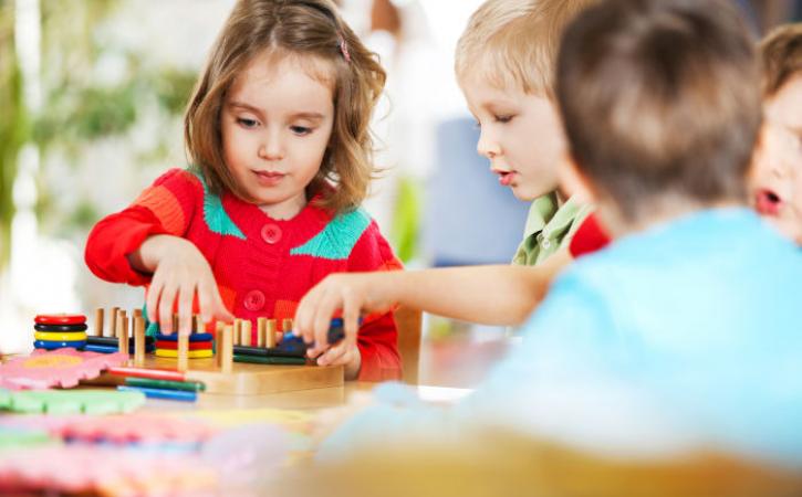 Teaching cooperation - children sharing toys