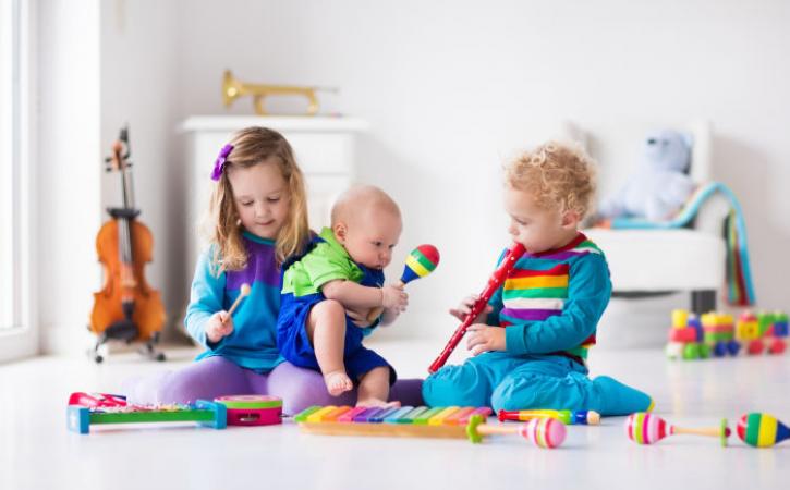 Three little siblings with musical instruments